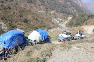 Trucks loaded with relief packages travelling in narrow hilly roads 1