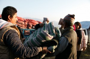 Sai youth handing over the package to beneficiary