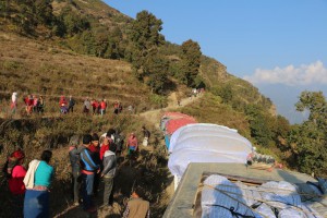 Villagers gathered to collect matresses